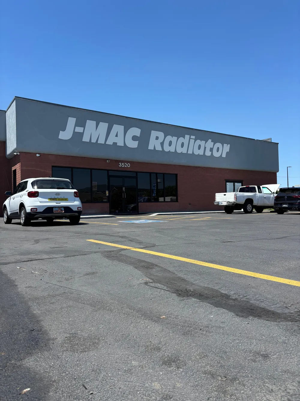 J-Mac Radiator sign and shop entrance at 3520 South State Street
