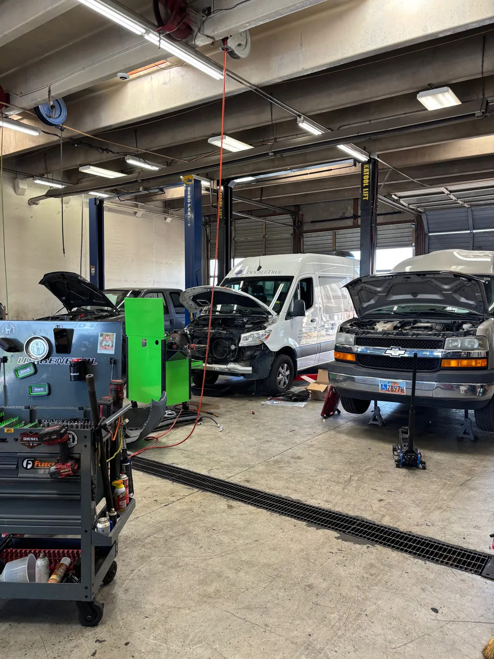 Commercial service vans with their hoods open at J-Mac Radiator